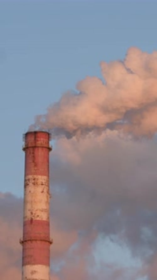 Industrial Chimney Emitting Plumes During Golden Hour