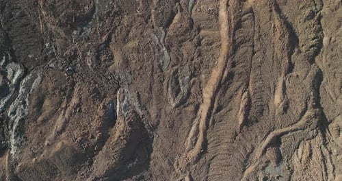 Solidified basalt rock formed by lava flows from volcanic eruption, top down