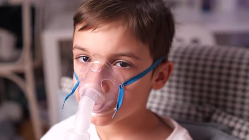 Closeup Boy Being Treated for Asthma Bronchitis Flu Cough Using Nebulizer
