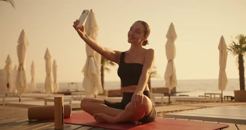 Woman Taking Selfie After Beach Yoga Session