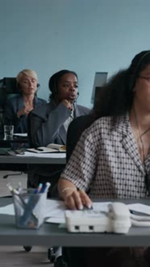 Young Intercultural Operators with Headsets Talking to Online Clients