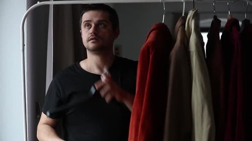 Man Getting Dressed Choosing Shirt from Rack