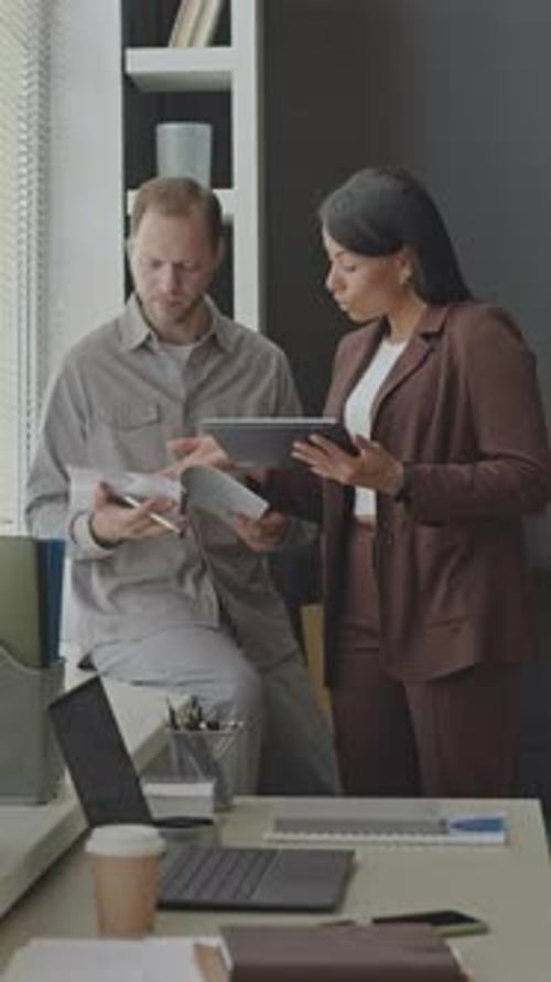 Colleagues Discussing Corporate Project in Office