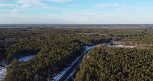 Drone Flying Forward Over the Driving Road Near a Forest