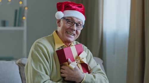 Senior Man Holding Christmas Gift Box
