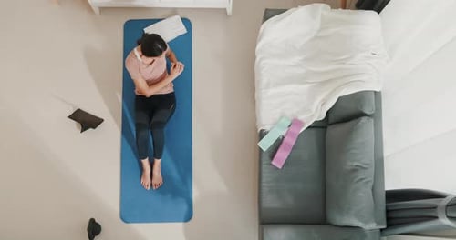 Asia woman in sportswear watching fitness online video on tablet with fitness ball.