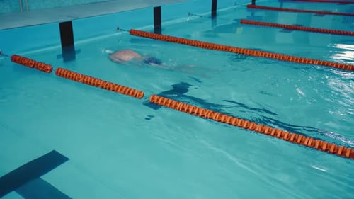 Athlete Swimmer Man Swims Makes a Turn Under Water and Continues to Swim in the Backstroke Style