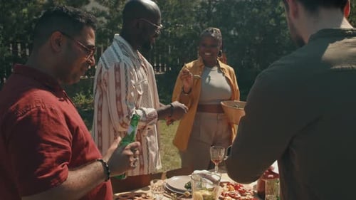 Friends Enjoying Food Together Outdoors on a Sunny Day