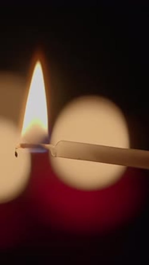 A Candle Flame That Illuminates a Dark Background Creating a Warm and Inviting Atmosphere