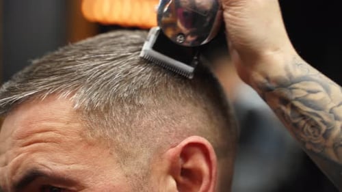 Barber Giving Haircut with Electric Trimmer Close Up