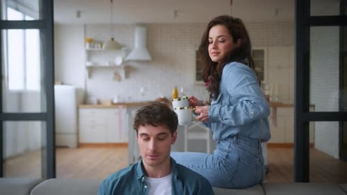 Woman Brings Coffee to Man Working from Home