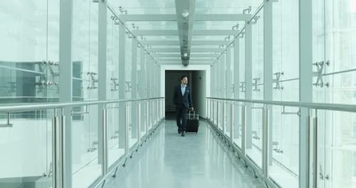 Businessman walking through airport terminal