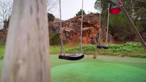 Empty swing in a children playground during Covid-19 coronavirus pandemic lockdown