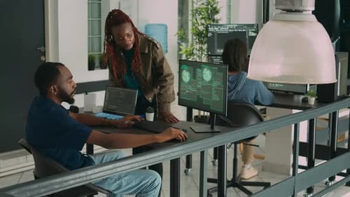 Team of Coders Discussing Computer Code in Office