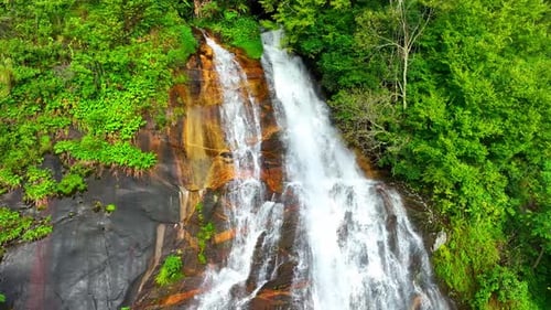 The beauty of the waterfall in the heart of the tropical forest.