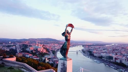 Budapest liberty statue and view of the early sun over the city