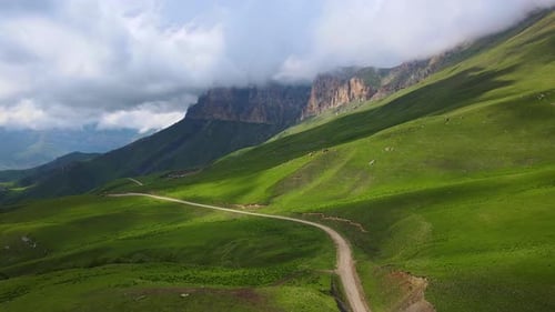 Actoprak's Green Mountain Pass Aerial View Day's Charm Cloud Embrace Majestic Mountain Pass Scenic