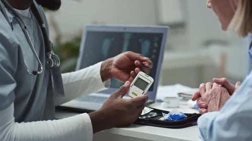 Medical Professional Testing Patient Blood Sugar Level in Clinic