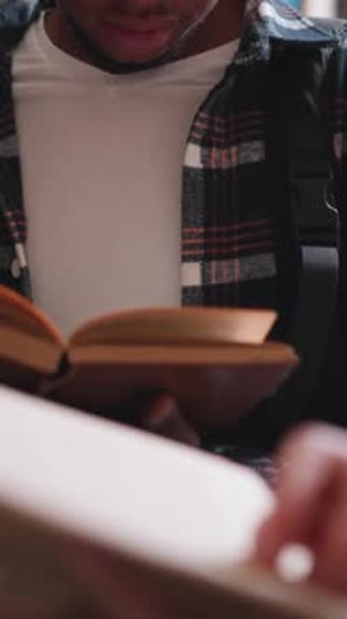 Students Positioned By Bookshelves in Library