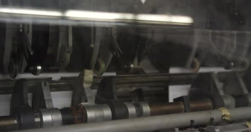 Paper Feeder In Printing Press. Working Paper Feeder Of An Industrial Printer. close up, slider shot