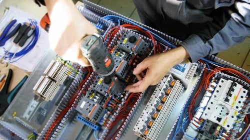 Electrician wiring electrical box in close up shot