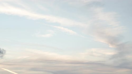 Pan from cloudy sky to smoking factory chimney - wide