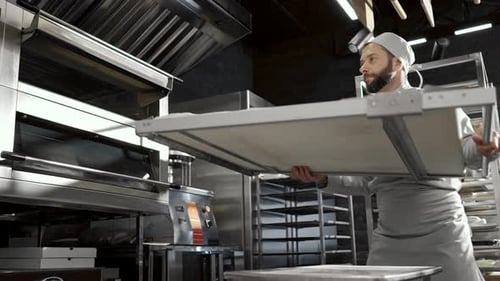 Baker Prepares Dough in Commercial Kitchen with Oven