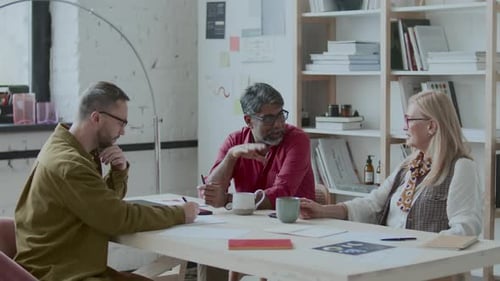 Group of Diverse Business People Discussing Plans at Meeting in Office