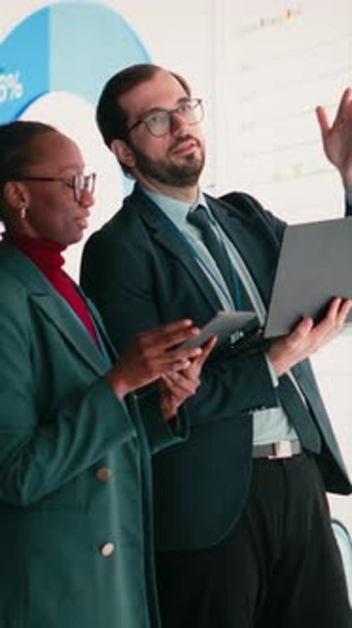 Vertical Video Compiling Financial Report Laptop and Female Executive with Business Partner