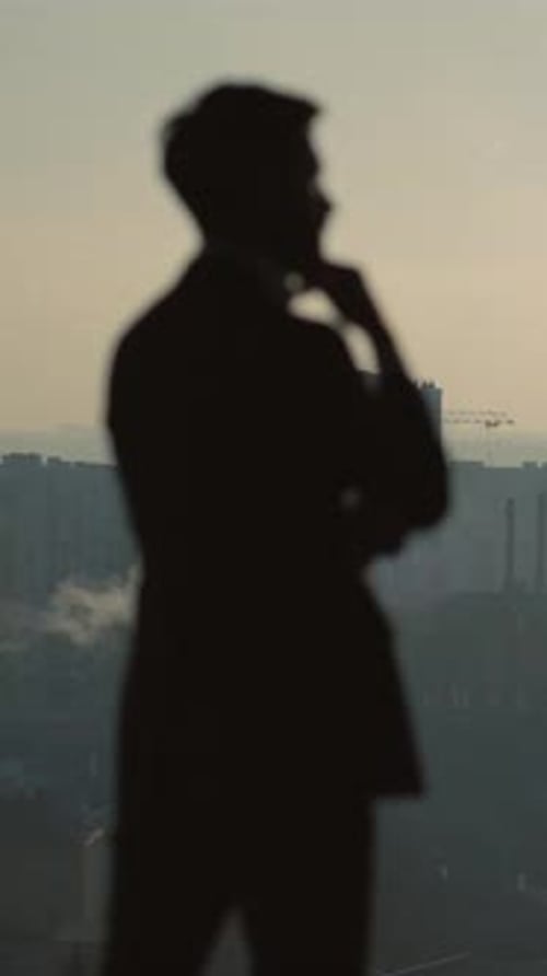 A Businessman in a City Skyline Reflects on Opportunity and Success