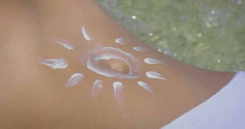 une jeune et jolie fille utilise des crèmes pour se protéger des rayons UV du soleil, pour se protéger