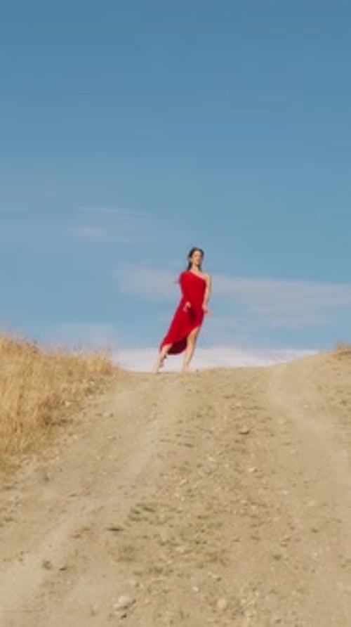 Ballerina In Red Dress Dances On A Hill In Sicily