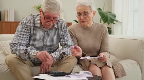 Mature Couple Calculating Finances at Home Together