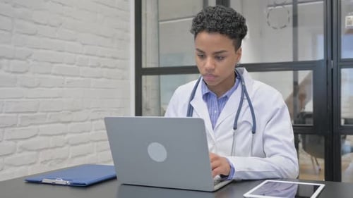 African Female Doctor having Headache in Clinic