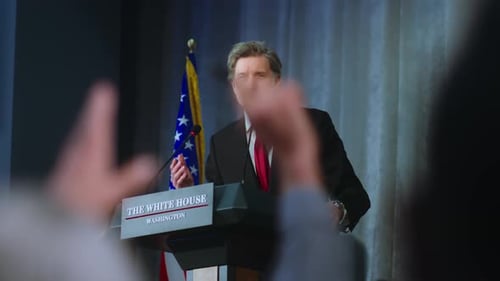 Man Speaking at Podium with American Flag