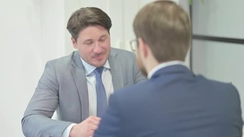 Businessman Talking with Customer in Office