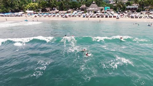 Two Surfers Ride The Wave In Sayulita, Mexico