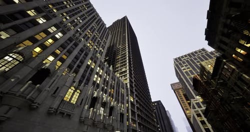 Tall Skyscrapers Illuminated at Dusk in an Urban City Environment