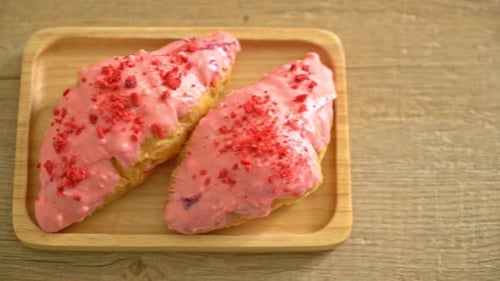 Pink Iced Croissants on a Wooden Serving Board