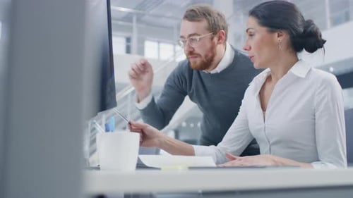 In Bright Modern Office: Beautiful Businesswoman Sitting and Working at Her Desktop Computer with P