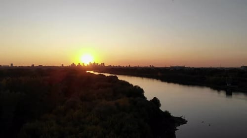 Aerial footage of sunset overlooking the city and river, warsaw