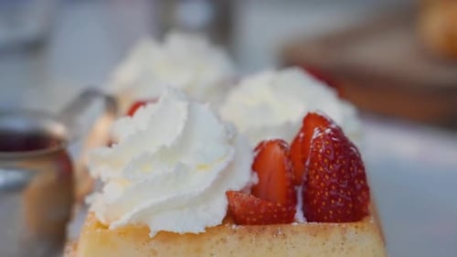 Close up of waffles, strawberries and whipped cream