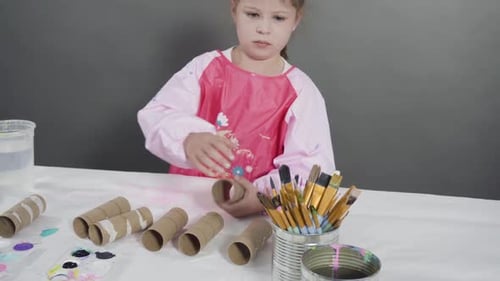 Kids Papercraft Painting Empty Toilet Paper Rolls with Acrylic Paint to Create Paper Bugs