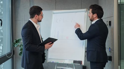 Business Professionals Discussing KPI Strategy in Office