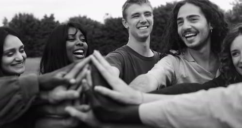 Diverse Young Adults with Hands Together in Park
