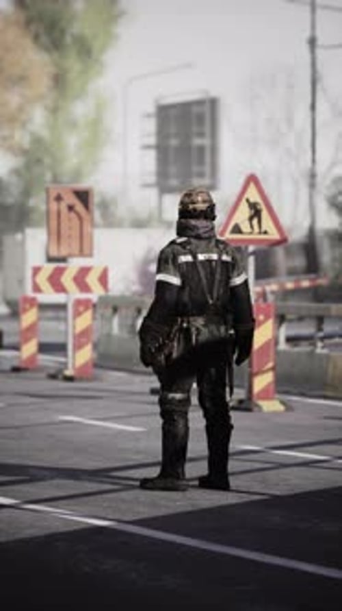 Road Worker Overseeing Construction Site on a Busy Urban Street