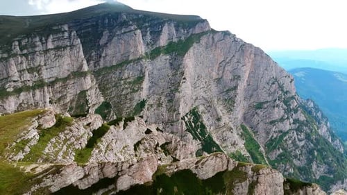 Footage above the Bucegi Mountains with a cross monument.