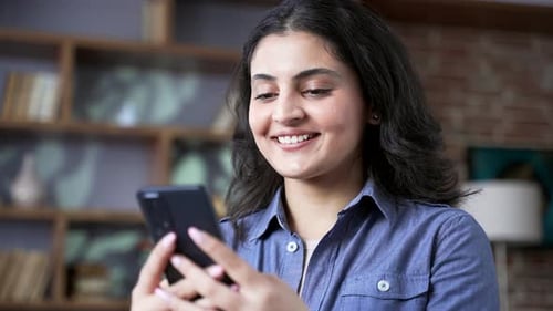 Smiling young woman using a mobile phone