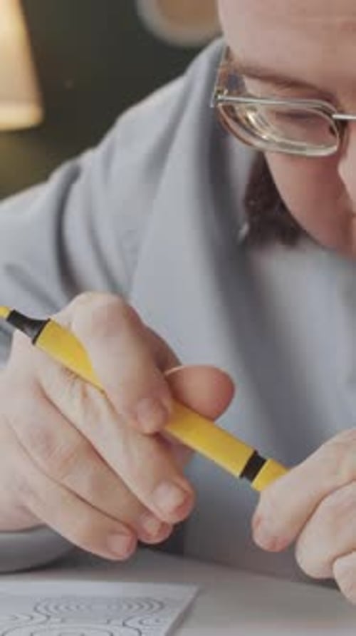 Person Coloring Concentric Circles Design with Marker