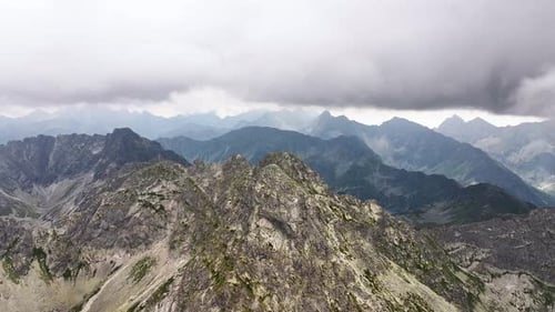 Majestic mountain range stretches under dramatic stormy skies
